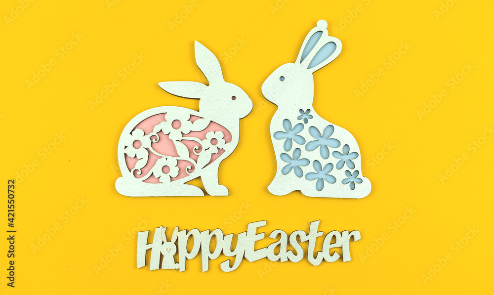 Fototapeta premium Easter bunny decoration on a yellow background, cute greeting card with text