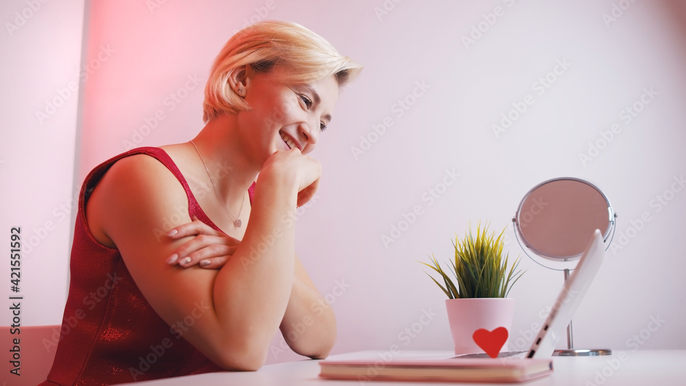 Young woman using laptop for online dating. . High quality photo Young woman using laptop for online dating. . High quality photo