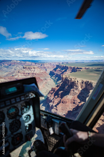 Magnificent view over Grand Canyon, Colorado River and the cockpit and blade of  our helicopter