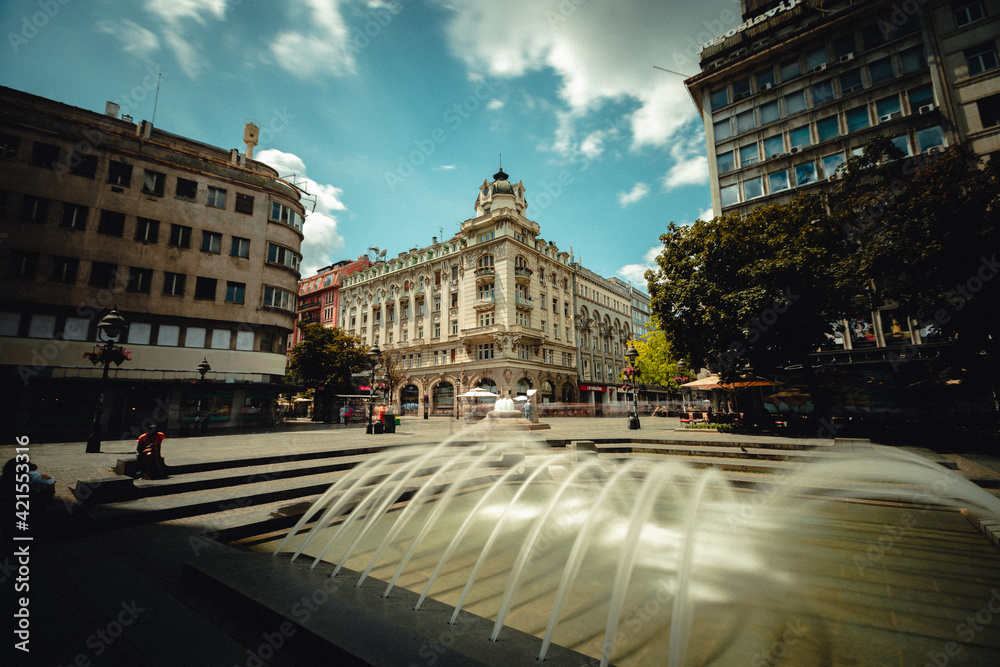 Low angle view of historic buildings and fountain in Belgrade city