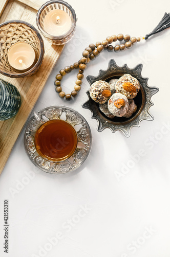 bowl with various pieces of Turkish delight locum and black tea with mint on a light background. Oriental sweets. copy space photo