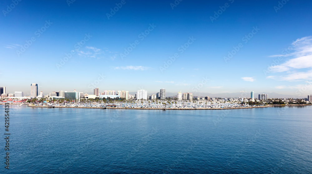 Southern California across the water with large boat marina and mountains visible