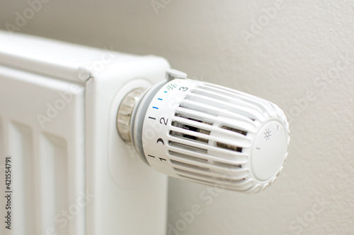 Thermostatic head and radiator valve. Close-up view. Energy saving and save money concept with copy space. Reduce consumption of gas or electricity.