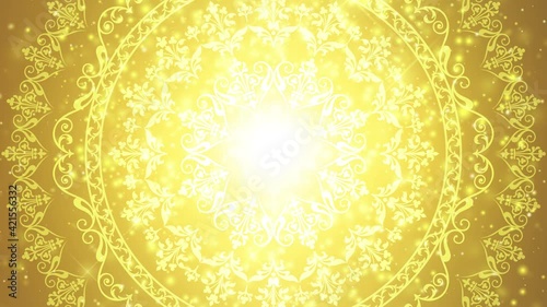 回転する円環模様と黄金色のキラキラ抽象背景。ループ動画。