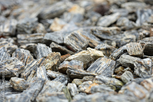 Crushed stone gray, light gray filling background close up © Daniel