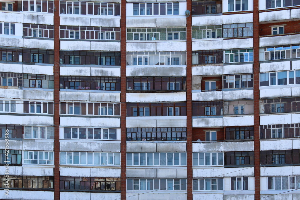 Many windows in a multi-storey building with balconies