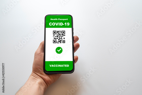 Vaccinated person using digital health passport application on mobile phone to travel during the COVID-19 pandemic