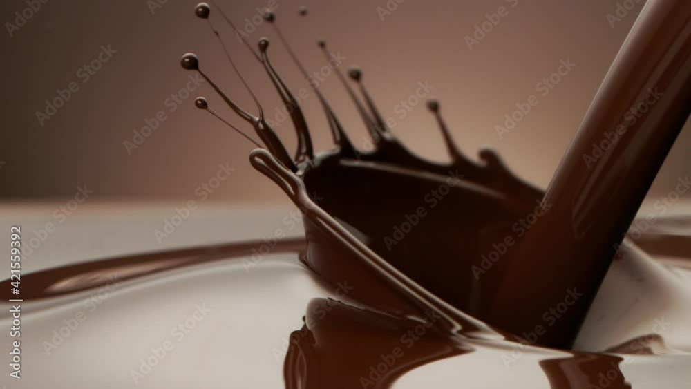 Super slow motion of pouring dark hot chocolate. Filmed on high speed cinema camera, 1000fps. Super slow motion of pouring dark hot chocolate. Filmed on high speed cinema camera, 1000fps.