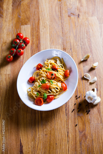 Fresh pasta with garlic Cherry Tomatoes and basil. Deliciosu  Pasta Plate. Raw vegan pasta. Spaghetti. Italian food. Italy. Roma. Fine dining. Healthy food. Fresca Pasta. Vegetarian photo