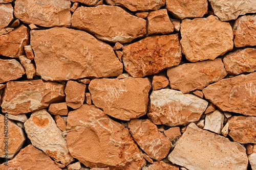 texture of a old red stone wall mediterrranean spain architecture, wall background photo