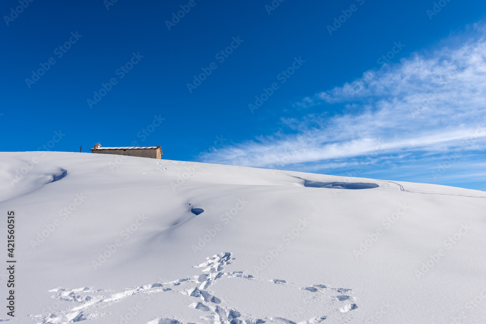 Lessinia Plateau in winter with snow and old dairy farm (Altopiano della Lessinia), Regional Natural Park, Malga Gaibana near Malga San Giorgio ski resort, Verona Province, Veneto, Italy, Europe.