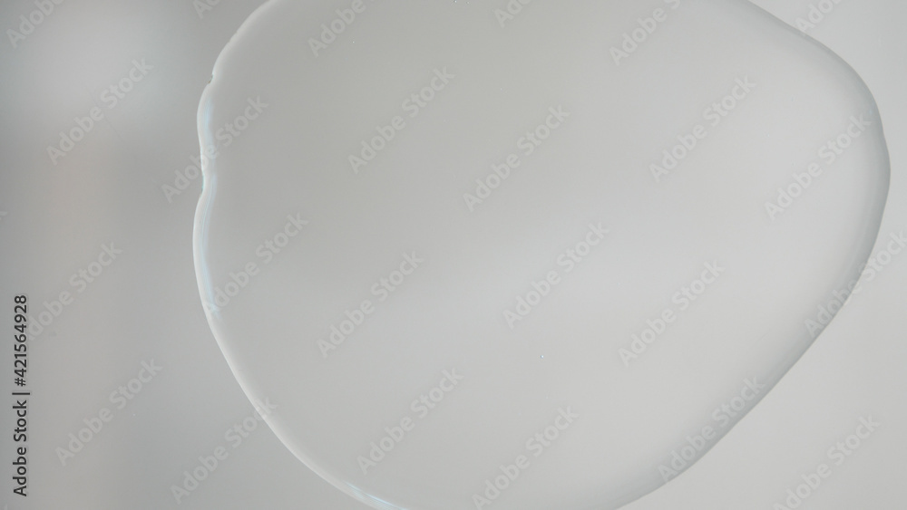 Pouring Oil Liquid. Oil Splashing and Flowing. Liquid cosmetic oil. Face and hands skin care concept. Sauna spa exotic therapy treatment for body. Pouring Oil Liquid. Oil Splashing and Flowing. Liquid cosmetic oil. Face and hands skin care concept. Sauna spa exotic therapy treatment for body.