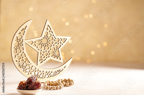 Ramadan kareem background . Golden Ramadan moon decor with Islamic rosary beads and dates fruit.