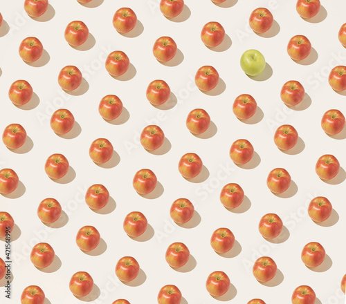 Fruity pattern made of red apples on a beige background