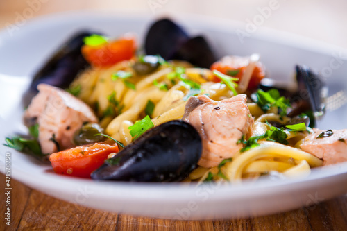 Pasta with seafood. Pasta with mussels and basil. Fresh Seafood fresh homemade pasta with mussels and parsley. Fresh Italian food. Mediterranean fresh sea food dish. Beautiful plate. fine dish