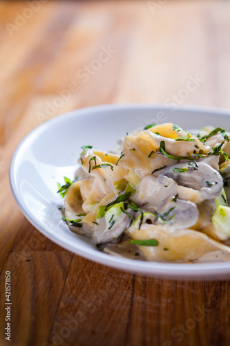 Tagliatelle pasta with asparagus mushrooms and basil in sour cream sauce. Italian pasta. fresh pasta 
culinary recipe