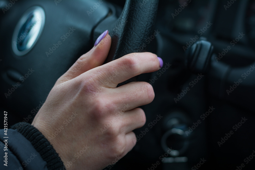 woman's hand on the steering wheel close-up
