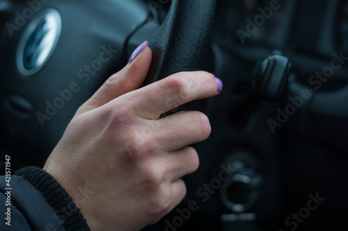 woman's hand on the steering wheel close-up © Todorean Gabriel