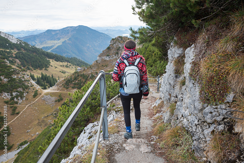 young woman with backpack at hiking path Wendelstein mountain