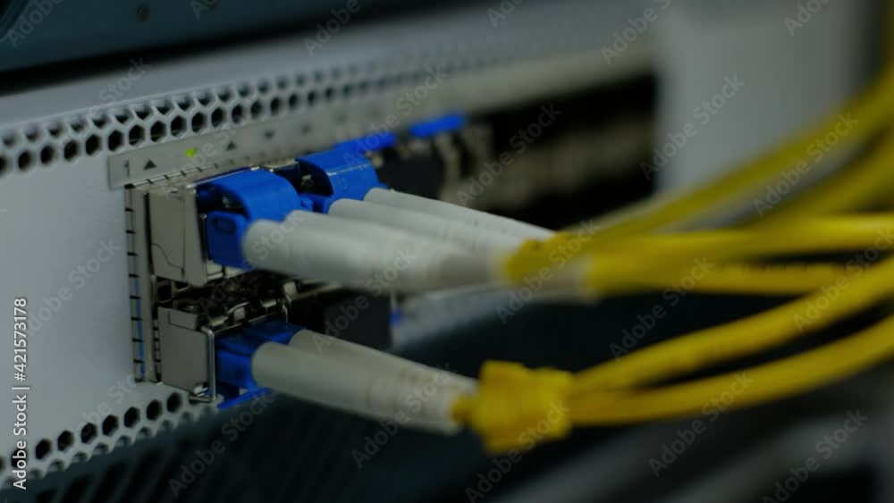 Close up. Fiber optic cable on module port. Network gigabit switch for high speed network in data center room. Close up. Fiber optic cable on module port. Network gigabit switch for high speed network in data center room.