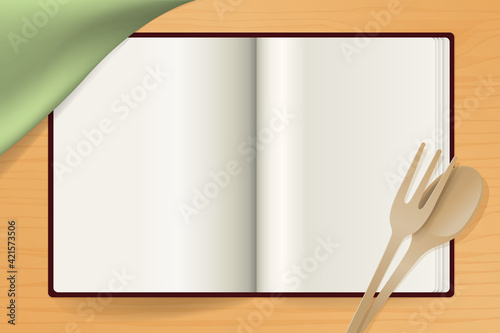 Composition avec un livre de cuisine vu du dessus avec des pages blanches pour écrire et présenter un recette.