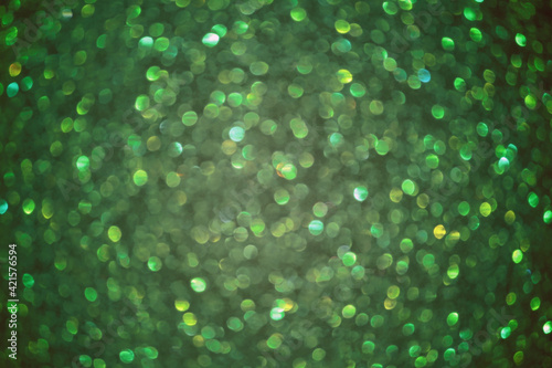 Emerald bokeh blured background glitter blur celebration happy new year 2021 2022 and 2023 christmas bright green lights on the dark background