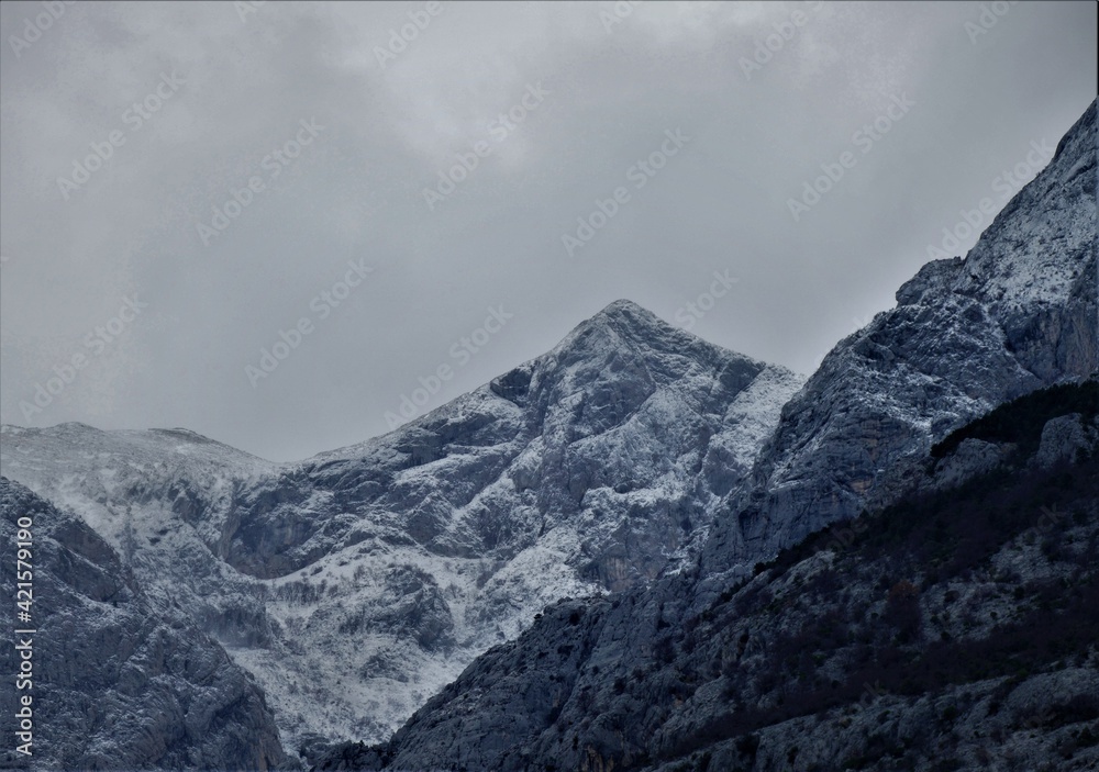 Mountain covered with snow and fogy clouds 