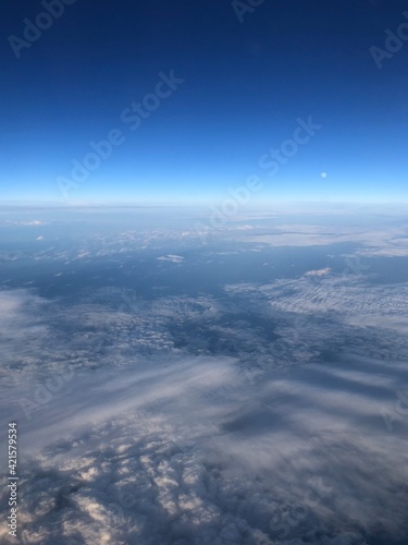 view from the plane window clouds and moon day