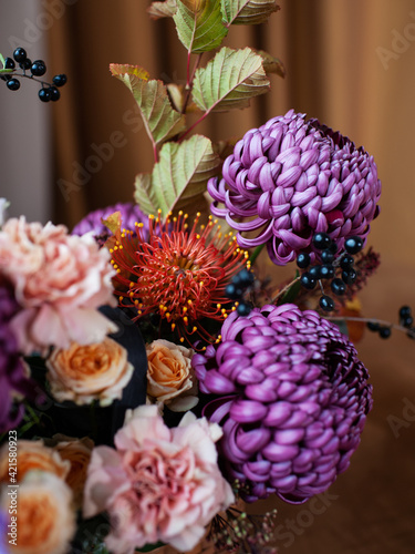 Fototapeta Naklejka Na Ścianę i Meble -  Closeup of flowers composition with banksia, purple chrysanthemum, rose, carnation and elderberry