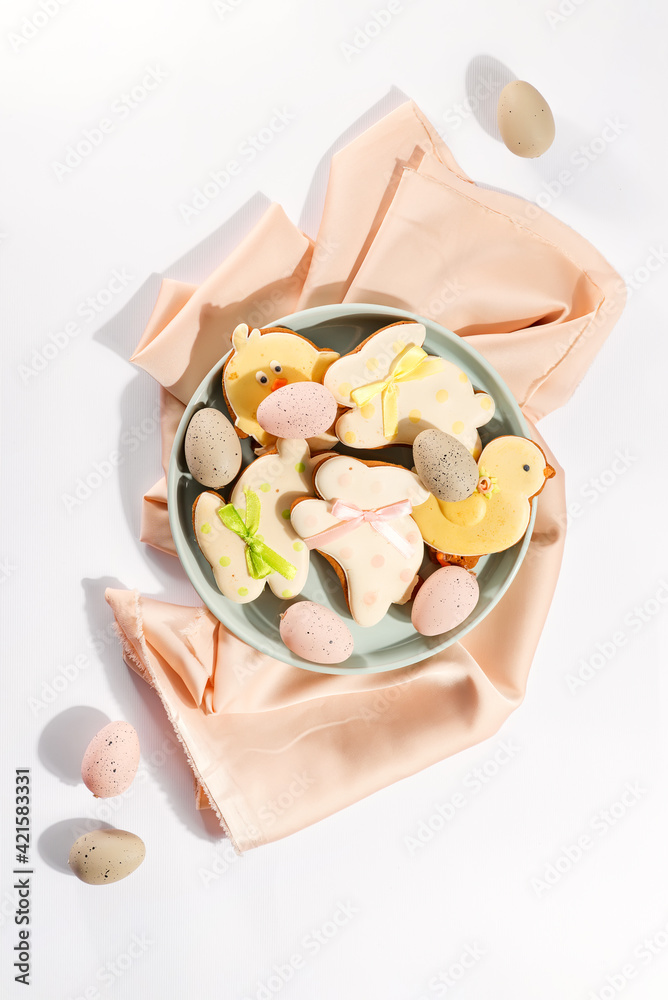 Easter gingerbread with icing and colored eggs on plate with napkin. Easter gingerbread with icing and colored eggs on plate with napkin.