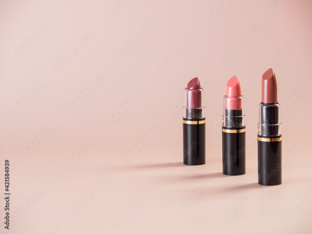 Open lipsticks on a powdery background. Side view Open lipsticks on a powdery background. Side view