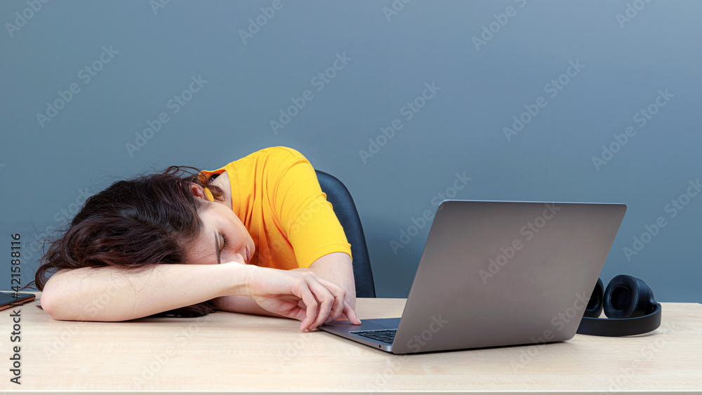 young female student sleeping near laptop during learning at home, distance online education young female student sleeping near laptop during learning at home, distance online education
