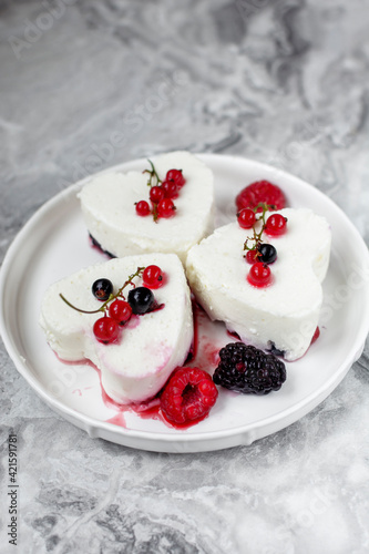 Panna Cotta with fresh berries on white plate. Delicious homemade dessert as tasty breakfast