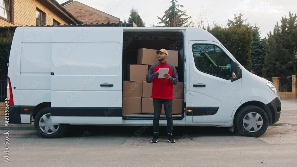 Young delivery man using tablet to find the address and deliver parcel. High quality 4k footage Young delivery man using tablet to find the address and deliver parcel. High quality 4k footage