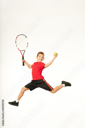 Cute male child playing tennis and jumping © Friends Stock