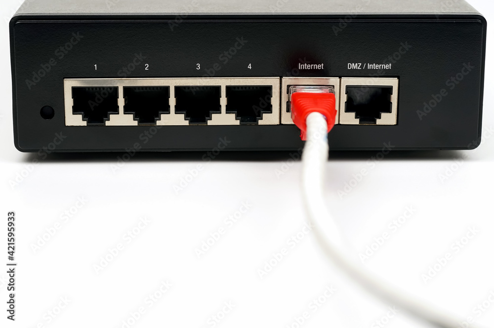Fotografie Person plugging in cable to wireless router. Close up.