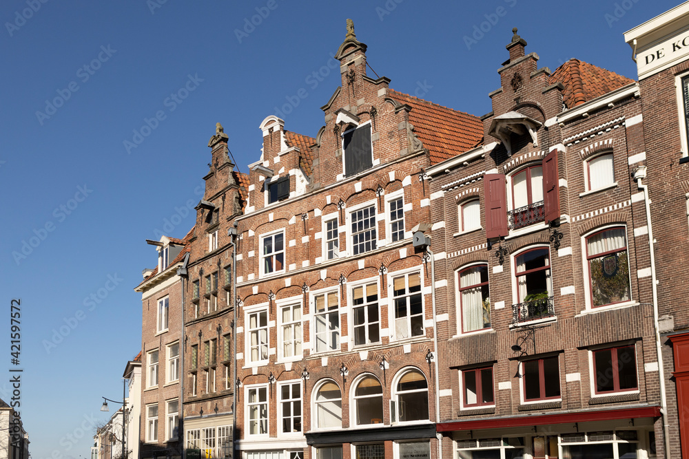 Typical historic medieval exterior facades of Hanseatic city center Zutphen in The Netherlands against a clear blue sky. Europe tourism destination.