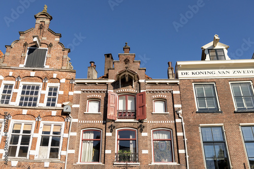 Architectural detail of typical historic medieval exterior facades in Hanseatic city center Zutphen, The Netherlands, against a clear blue sky. Europe tourism destination.
