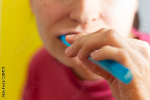 Girl with dental braces and brackets holding toothbrush for dental hygiene