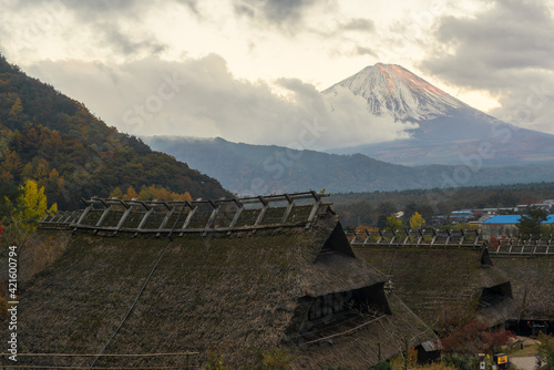 Views of the peak of Mt Fuji covered in snow as seen from the historical town of Iyashinosato photo