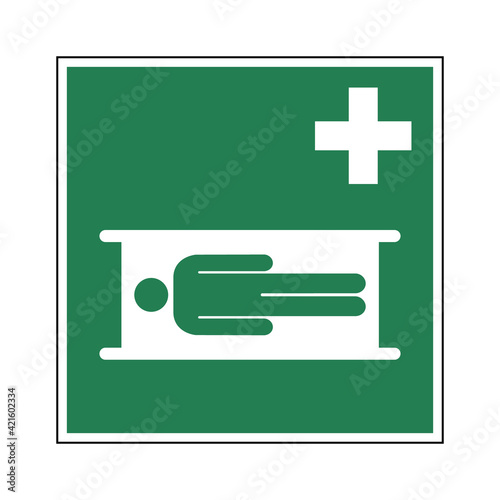 Stretcher sign. Vector illustration of green square sign with human figure on a stretcher icon inside.