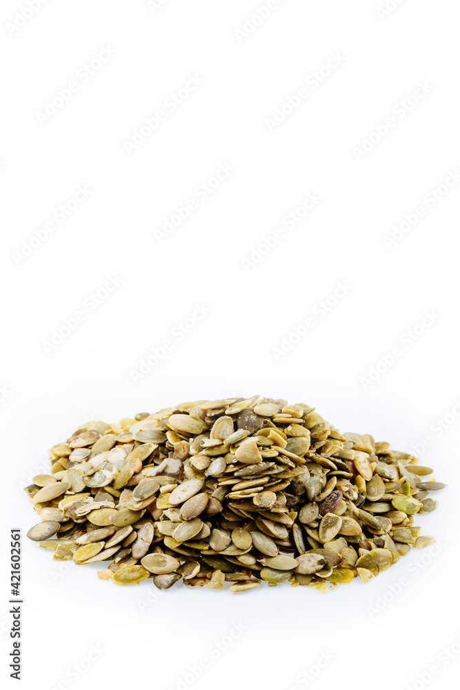 Heap of fresh shelled pumpkin seeds isolated on white. Peeled pumpkin seeds. Heap of fresh shelled pumpkin seeds isolated on white. Peeled pumpkin seeds.