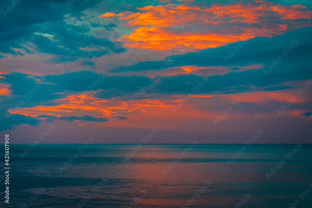 Beautiful sky with clouds over the ocean at sunrise 