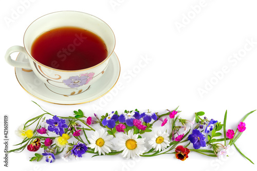 Elegant vintage cup with tea and a bouquet of flowers isolated on a white. Free space for text.