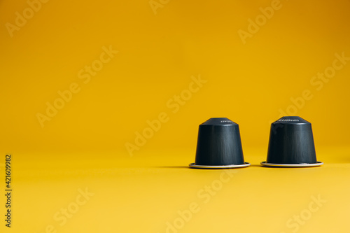 Two exclusive coffee capsules with copy space