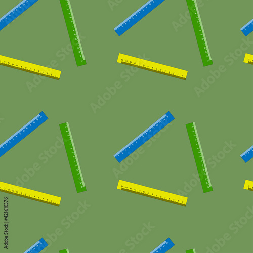 Colored centimeter rulers on a green seamless background.