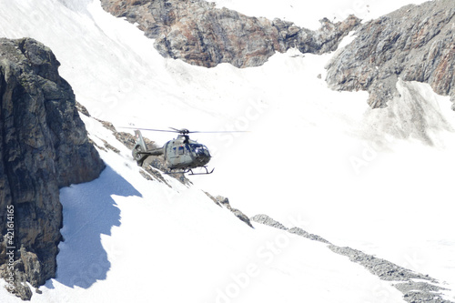 Swiss Airforce EC 635 Helicopter flying over a glacier photo