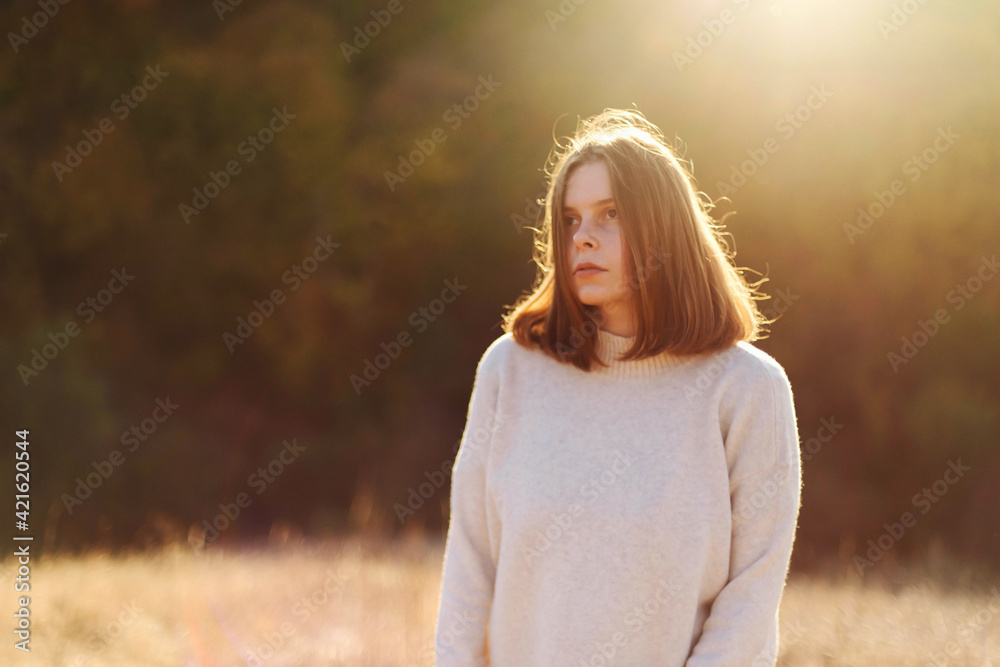 Beautiful portrait of a young stylish woman on a sunny day in autumn. Beautiful portrait of a young stylish woman on a sunny day in autumn.