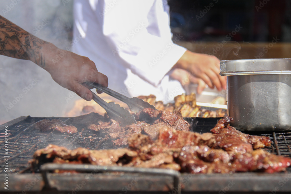delicious grilled meats cooked by the chef during a sunny day