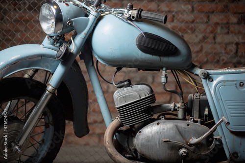 Old garage concept background. Retro style dusty motorcycle in the workshop. © Dmitriy